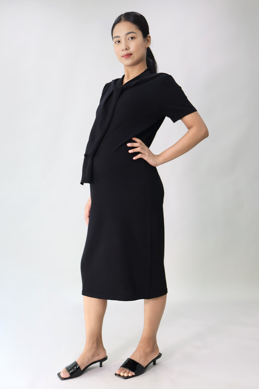 Bump-friendly black knit maternity midi dress side view