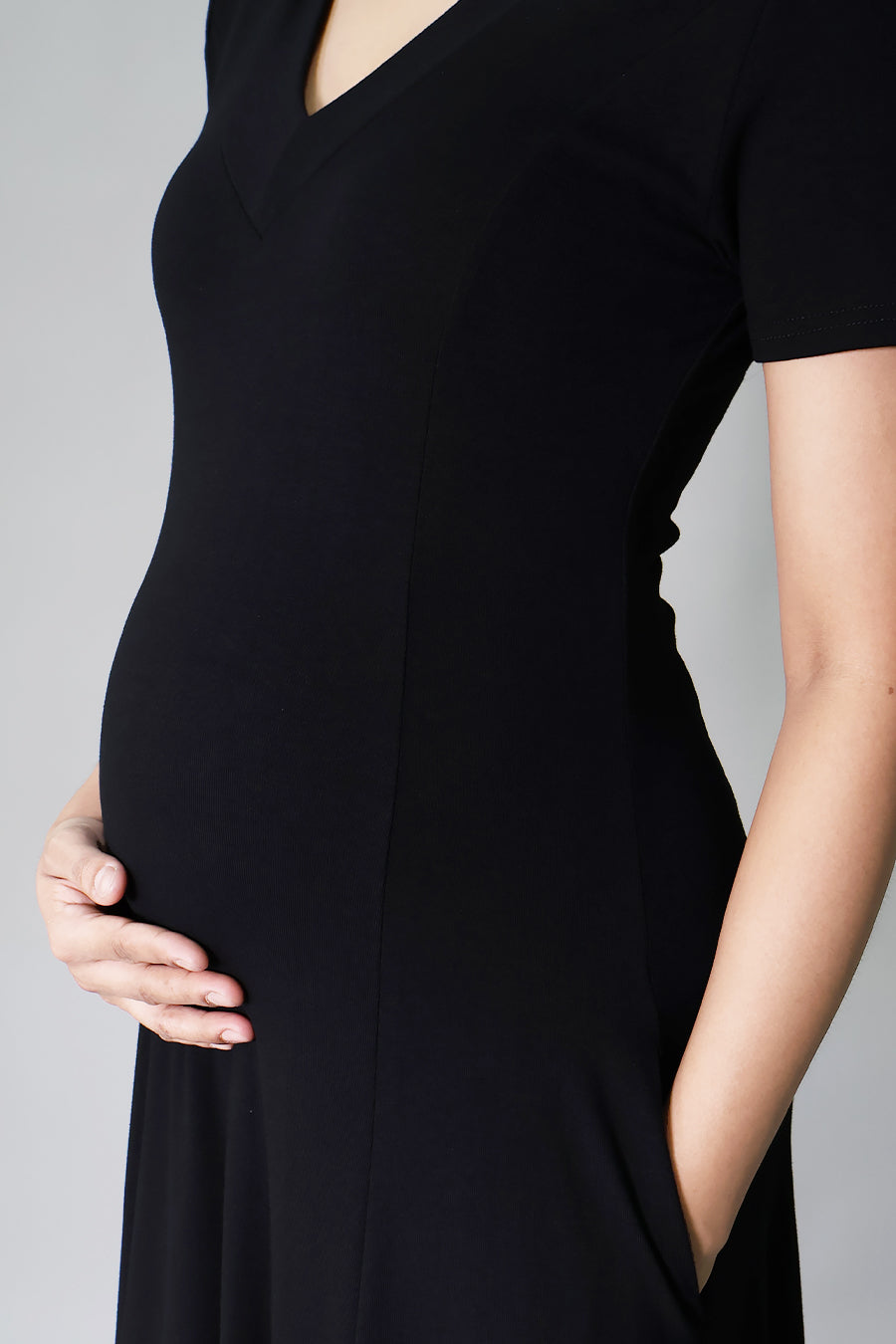 close up detail black maternity dress with pockets