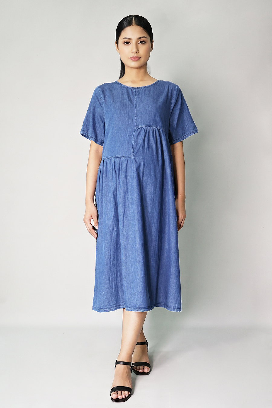 Pregnant woman wearing roomy cotton denim maternity dress