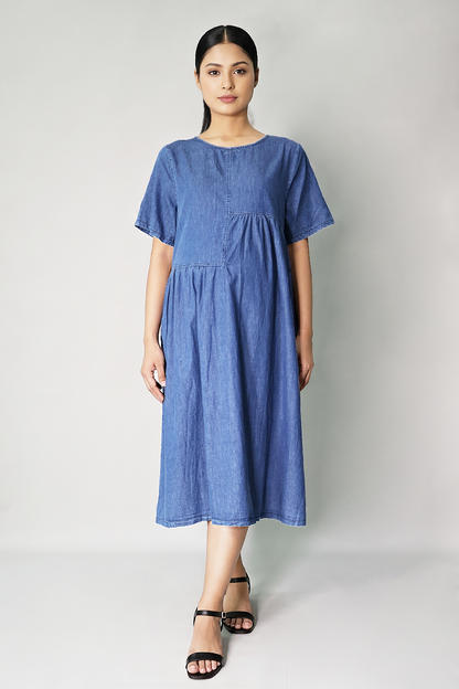 Pregnant woman wearing roomy cotton denim maternity dress