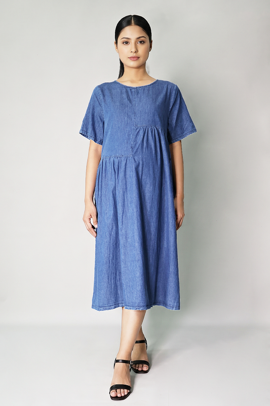 Pregnant woman wearing roomy cotton denim maternity dress